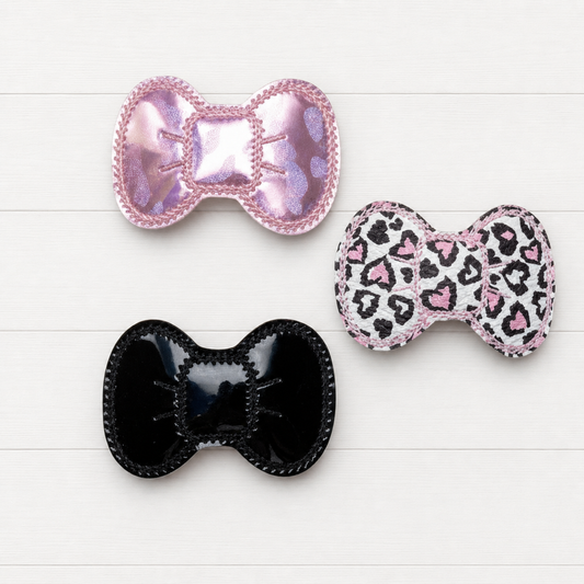 Valentine Leopard Hair Bow clip Set on a clean white wood background