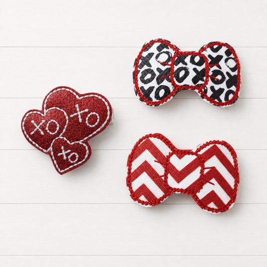 Xoxo Valentine Hair Bow Clip Set on a clean white wood background