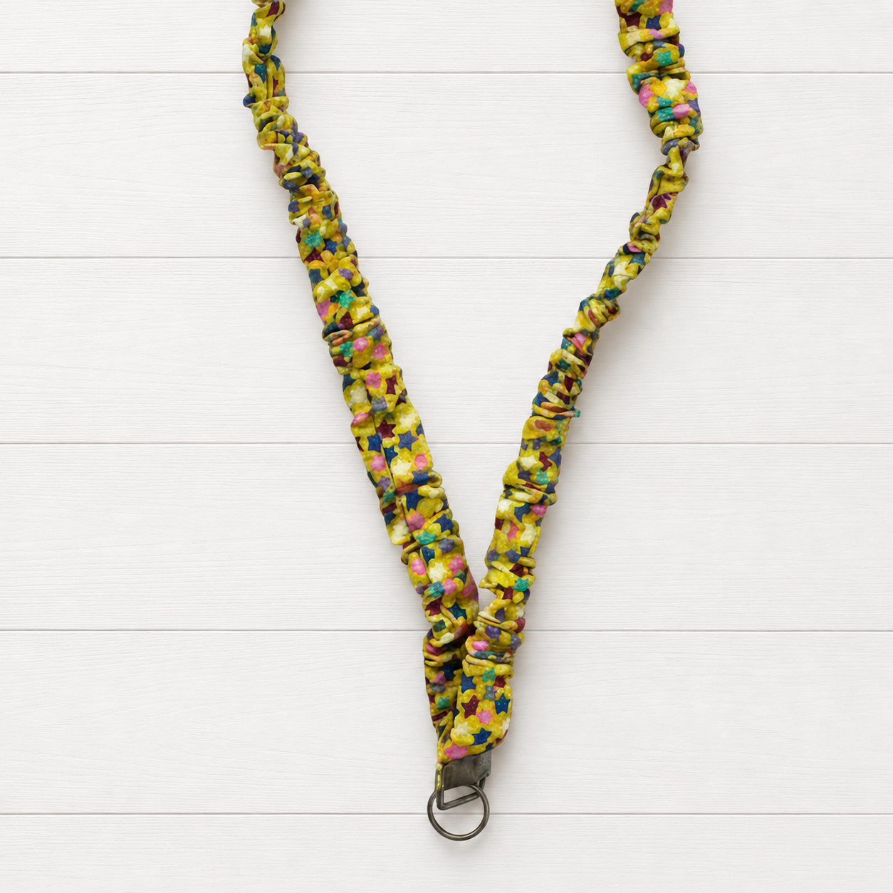 Yellow Stars Scrunchie Lanyard on a clean white wood background