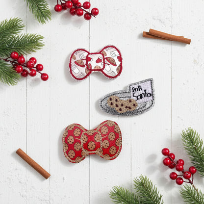 Three decorative bows with cookie designs on a white background